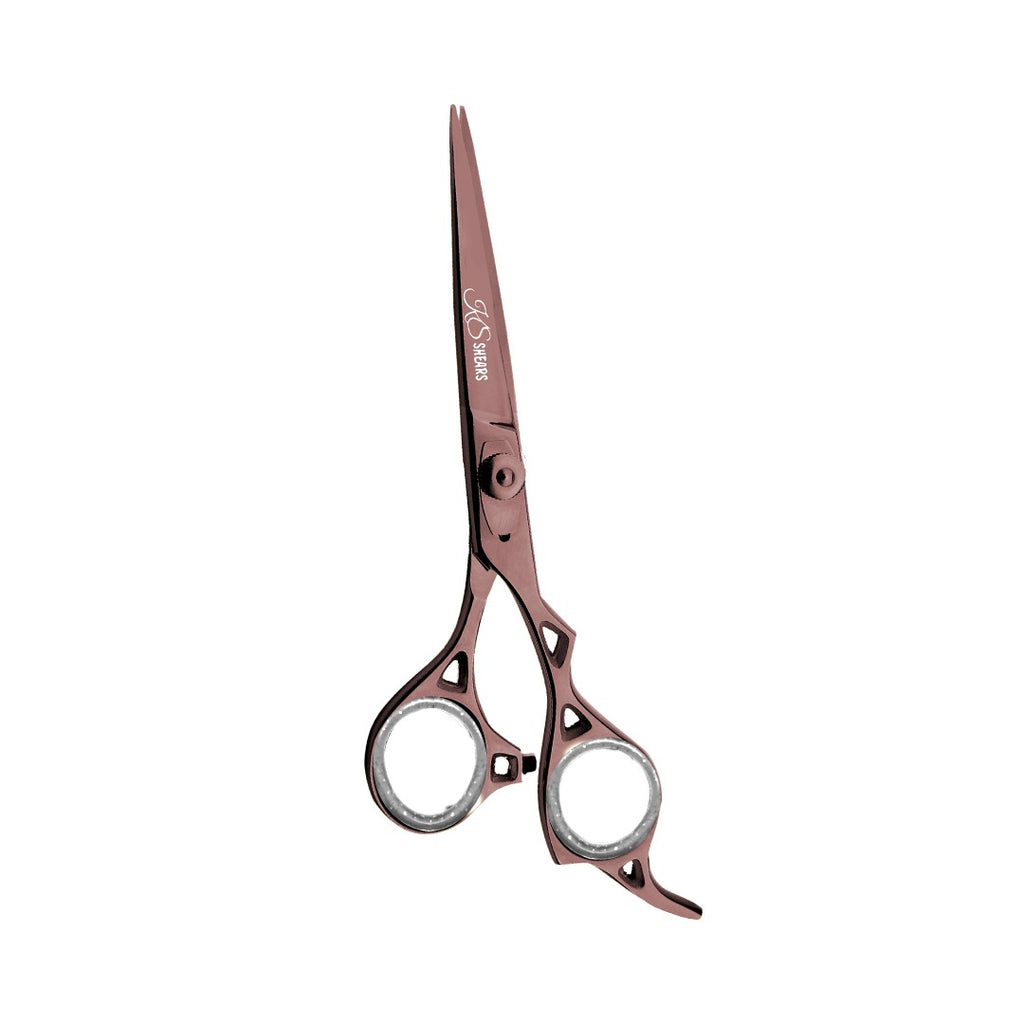 Rose gold hair cutting scissors on a white background